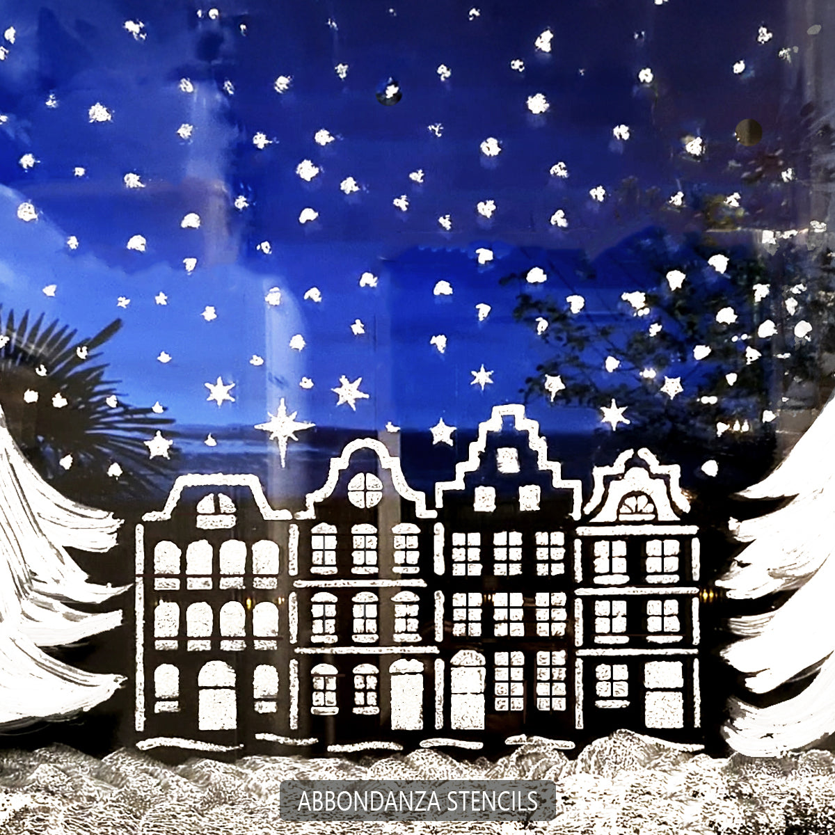 Schablonen-Weihnachtshäuser, die auf ein Fenster schabloniert sind